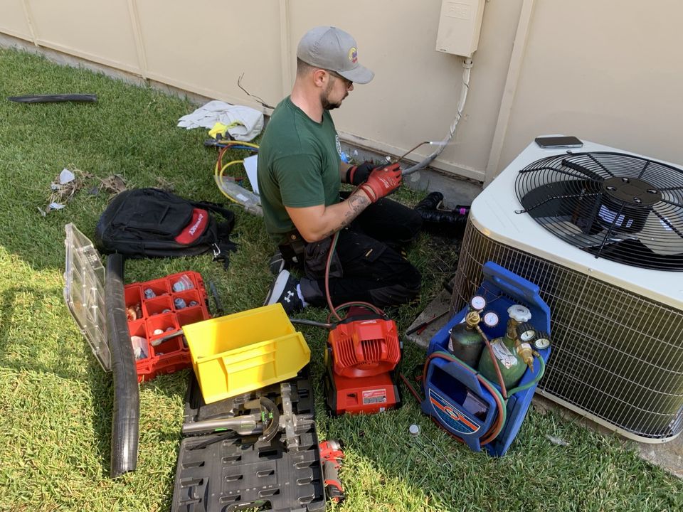 SmartWay technician diagnosing an outdoor AC condenser in a residential backyard in Collin County