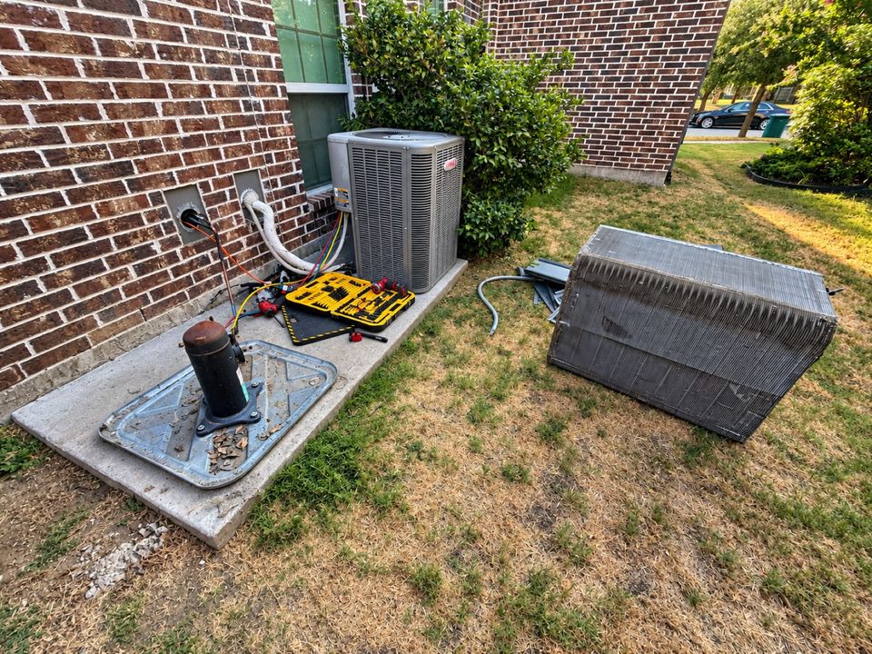 SmartWay technician servicing an outdoor HVAC unit in a residential backyard in Celina