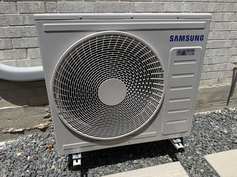 Mini split outdoor condenser unit installed outside a home in Allen