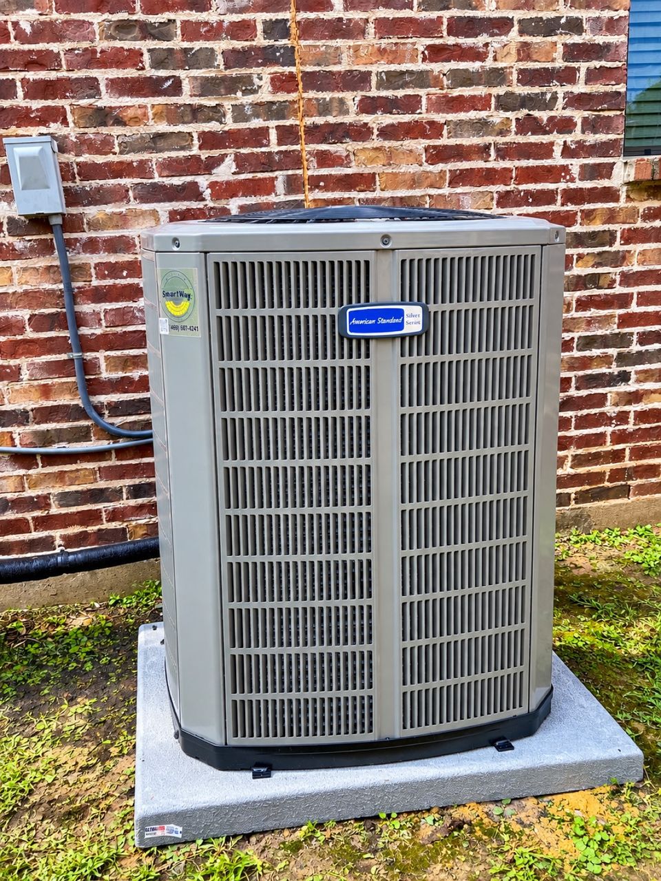 A new American Standard outdoor condenser unit installed after an AC replacement