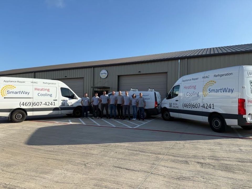 SmartWay crew and two lettered vans in front of the McKinney shop