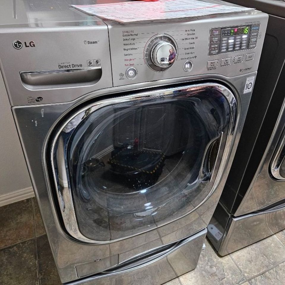 Front of an LG front-load washer with its round door and control panel visible